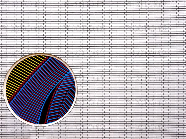 Part of a brick wall with a circular mosaic