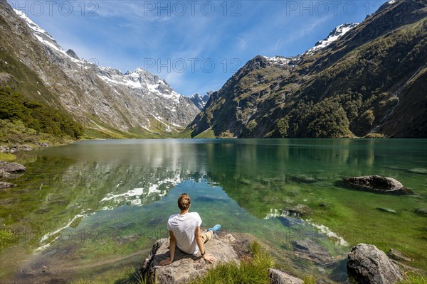 Hiker sitting on the shore