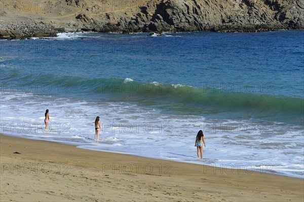 Bathers at the beach of Quebrada de la Huaca