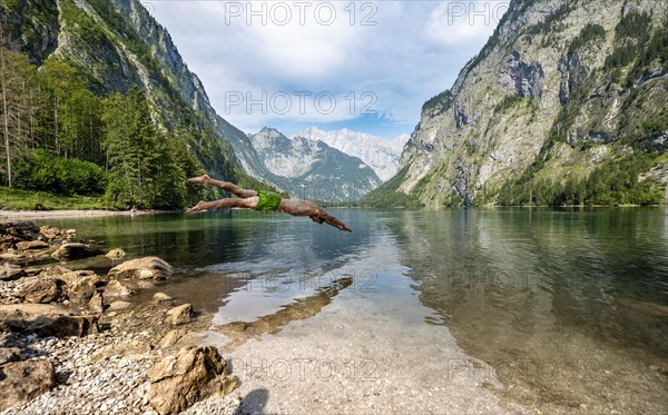 Young man jumps into lake