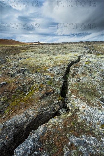 Volcanic fissure Grjotagja with coloured moss in the Krafla