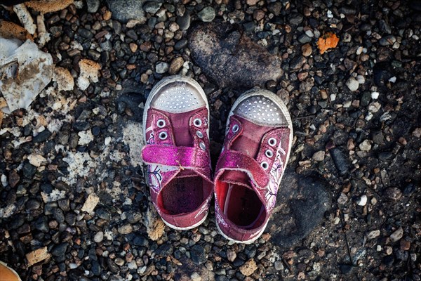 Girls' shoes in front of a tent