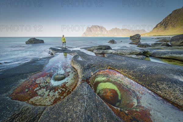 Woman standing on rocks on the beach