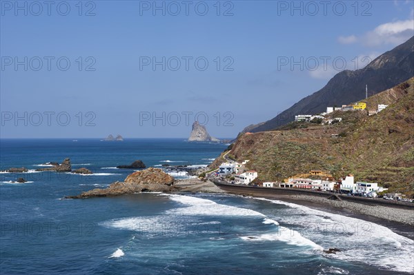 Coastal road with cliffs in the Anaga Mountains with beach section Playa de Roque de las Bodegas near the township of Taganana