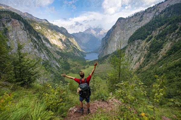 Hiker stretches arms in the air