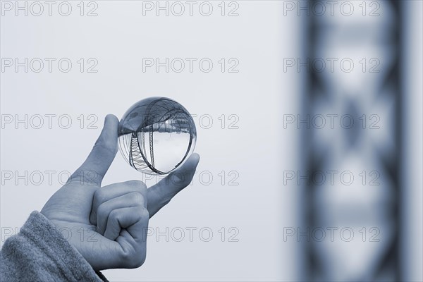 Hand holding glass ball