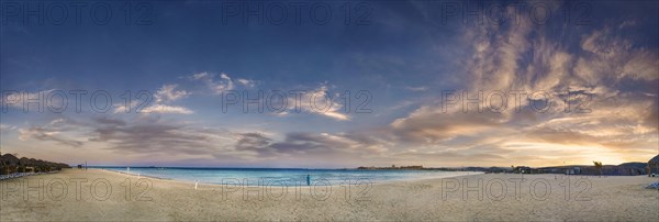 Sandy beach beach and coral reef Abu-Dabbab at sunset