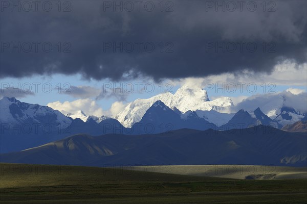 Mountain range of the Cordillera Blanca under dark clouds