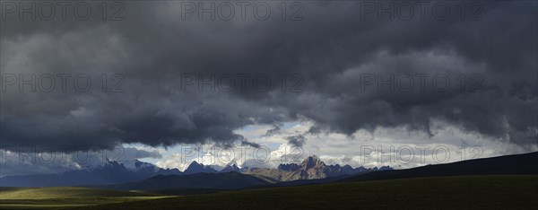 Mountain range of the Cordillera Blanca under dark clouds