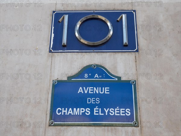 A plaque with the number 101 and a plaque with the name of the Avenue des Champs-Elysees