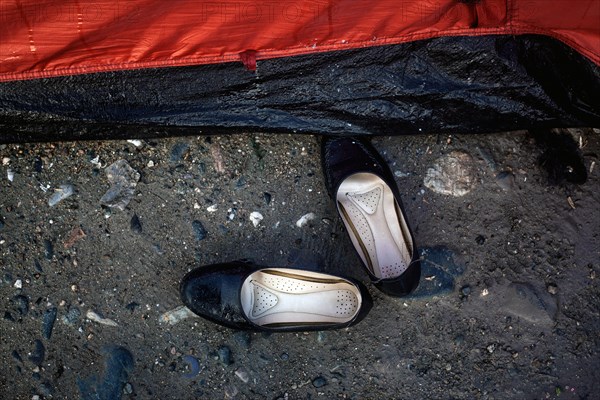 Girls' shoes in front of a tent