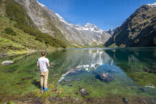 Hiker stands on shore