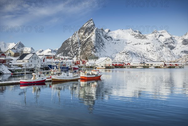 Fishing village with fishermen's cabins and jetty in winter by the fjord