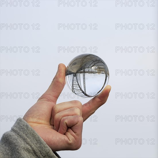 Hand holding glass ball