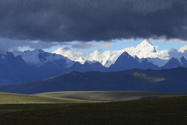 Mountain range of the Cordillera Blanca under dark clouds