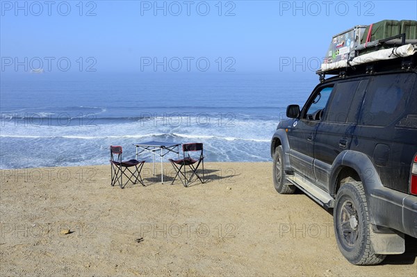 Camping furniture and off-road vehicles at Supay Beach