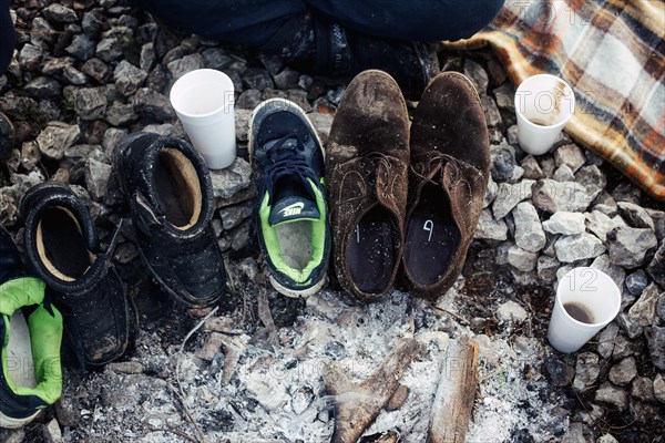 Several pairs of shoes in front of a tent