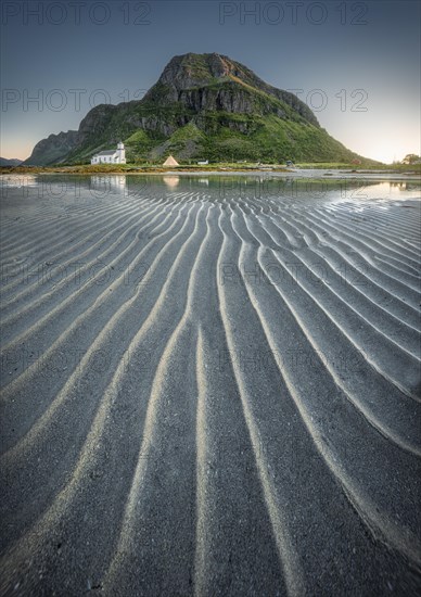 Gimsoy church reflected in the sea at low tide