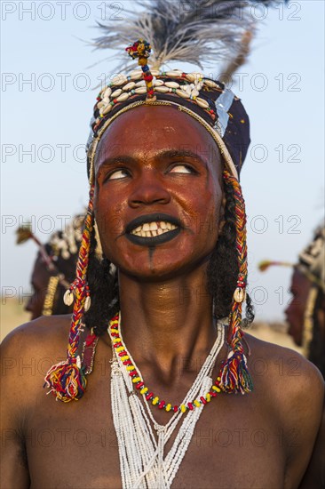 Wodaabe-Bororo man with his face painted at the annual Gerewol festival