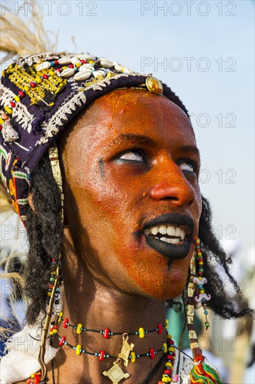 Wodaabe-Bororo man with face painted at the annual Gerewol festival