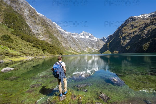 Hiker stands on shore