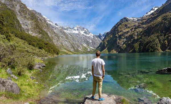 Hiker stands on shore