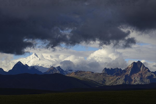 Mountain range of the Cordillera Blanca under dark clouds