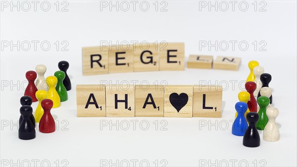 Letter stones with many different coloured game pieces in a small space