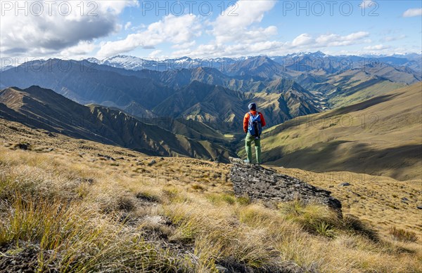 Hiker stands on stone