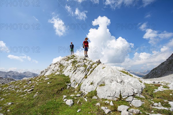 Two hikers standing on a rock