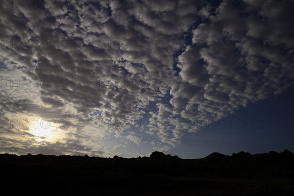 Night sky with clouds and full moon in the Quebrada de la Huaca