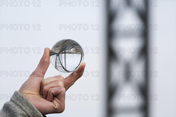 Hand holding glass ball