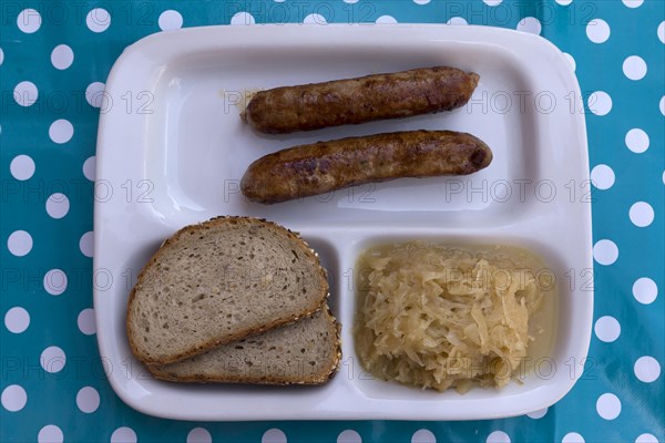 Fried sausages with sauerkraut and bread