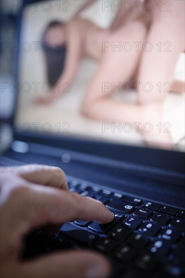 Man watches porn movies on the Internet on his computer