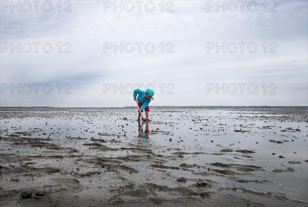 Child playing in the mudflats