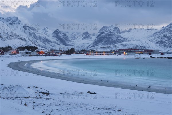 Snowy landscape at sea bay with sandy beach