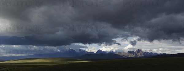 Mountain range of the Cordillera Blanca under dark clouds