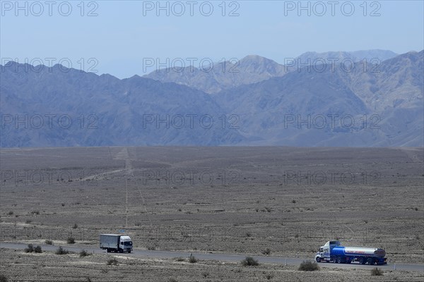 Trucks on the Panamericana drive past the lines of Nasca