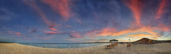 Sandy beach beach and coral reef Abu-Dabbab at sunset