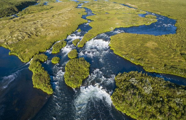 Aerial view of small green grass-covered islands in the river Laxa i Aoaldal