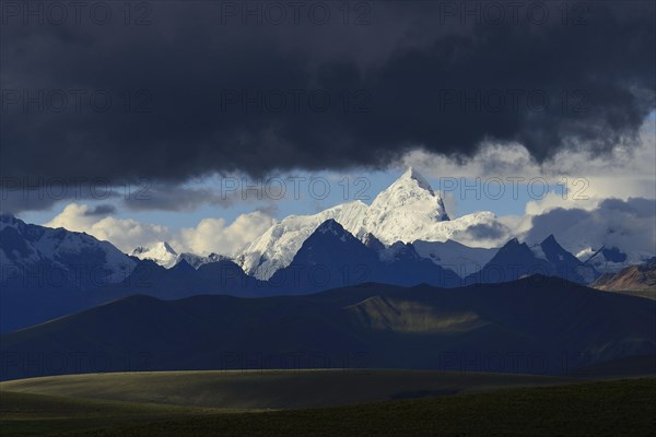 Mountain range of the Cordillera Blanca under dark clouds