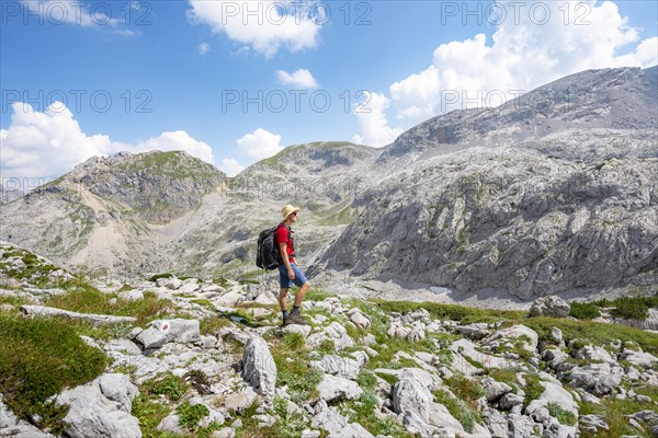 Hikers in a landscape of washed out karst rocks