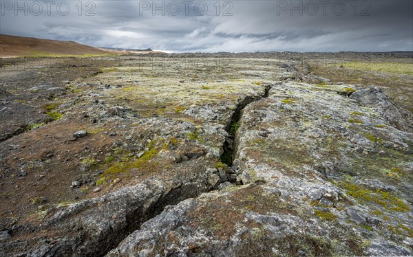 Volcanic fissure Grjotagja with coloured moss in the Krafla