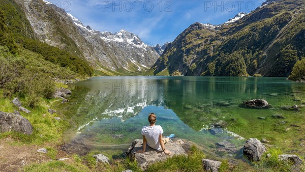 Hiker sitting on the shore