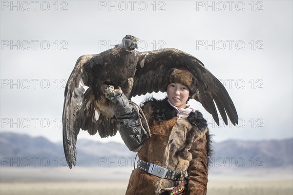 Young eagle hunter with her female eagle