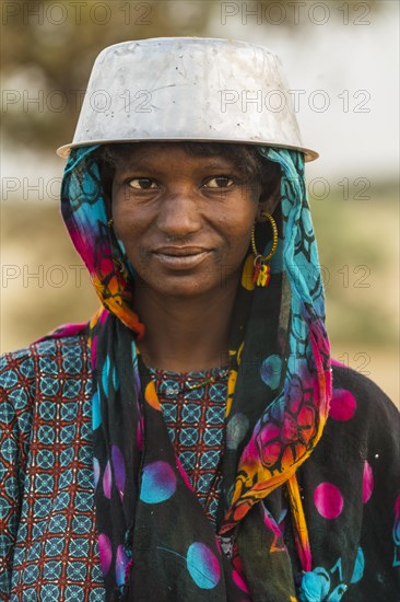 Young girl with a a water pot on her head