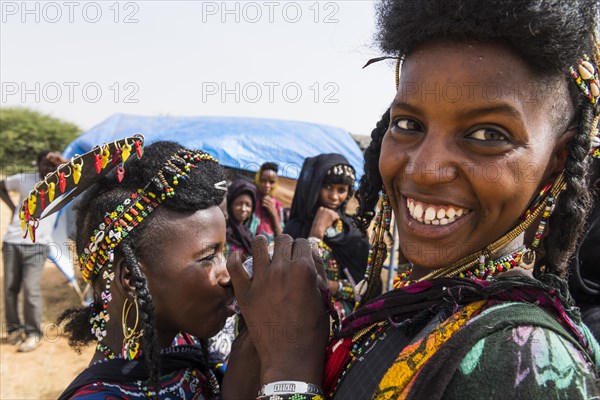 Two girls sharing a waterbag