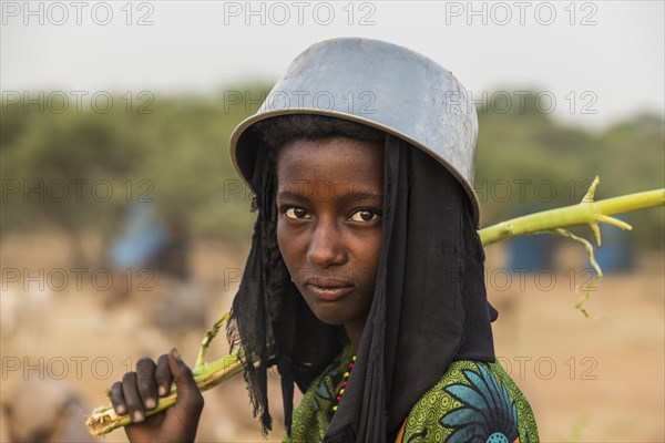 Young girl with a a water pot on her head