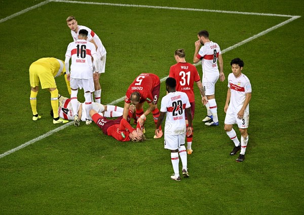 Marc-Oliver Kempf VfB Stuttgart and Sebastian Bornauw 1st FC Koeln injured on the ground Mercedes-Benz Arena