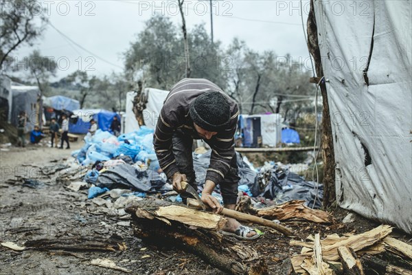 Fugitive in camp chopping firewood